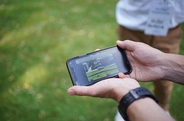 Close view on a smartphone showing a Agnet video streaming and hold by a professional user for a Broadway field test Close view on a smartphone showing a Agnet video streaming and hold by a professional user for a Broadway field test