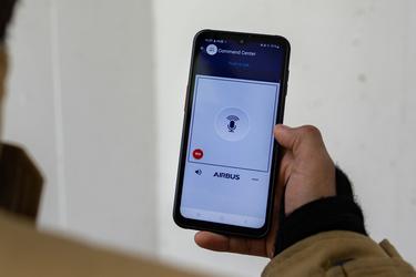 Close view on smartphone with Agnet push-to-talk user interface hold by professional user Close view on smartphone with Agnet push-to-talk user interface hold by professional user