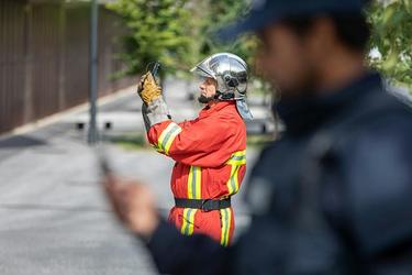 Fireman takes photo and police on the foreground Fireman takes photo and police on the foreground