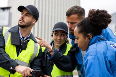 two police officers working with two paramedics during an emergency police female showing something offscreen  two police officers working with two paramedics during an emergency police female showing something offscreen