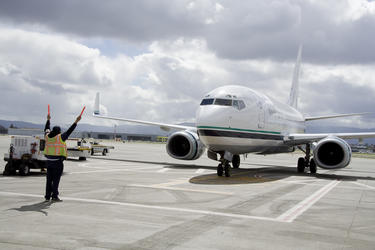 Airport worker signalling the pilot