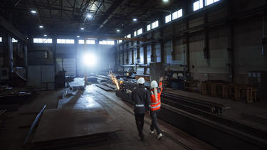 Industrial workers discussing Industrial workers discussing