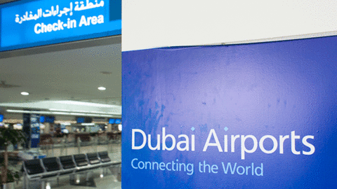 dubai airports sign "connecting the world" next to check in area