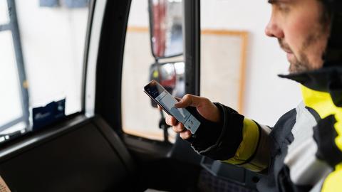Fireman using Agnet PTT feature on his smartphone in his fire truck