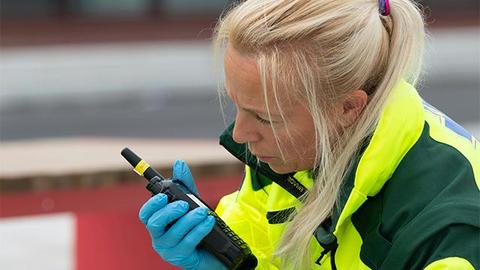 Paramedic talking to TH9 TETRA radio