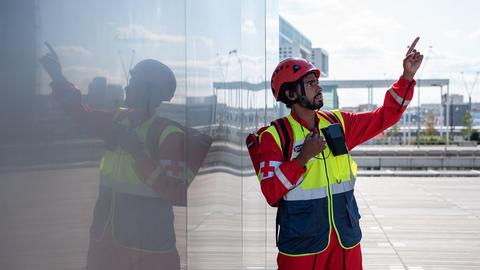Paramedic man using PTT device and pointing his finger on top