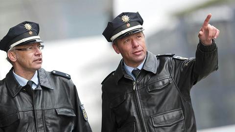 Two German police officers one pointing with finger