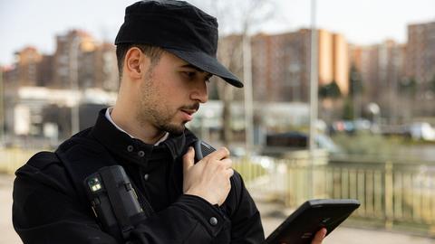 Security guard with tablet and push-to-talk