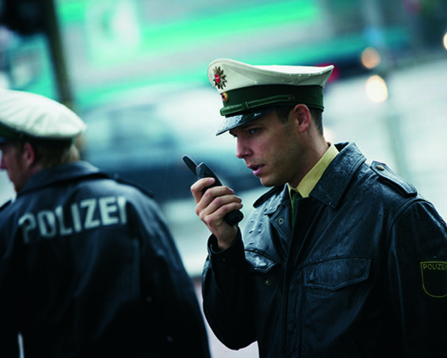 Police talking to a TETRA radio Police talking to a TETRA radio