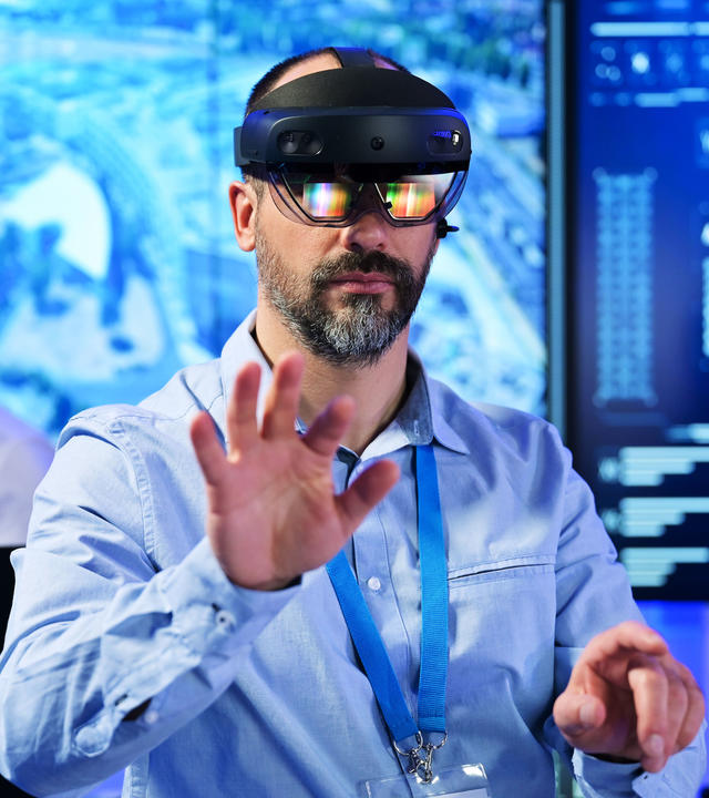Command and control room operator using VR glasses