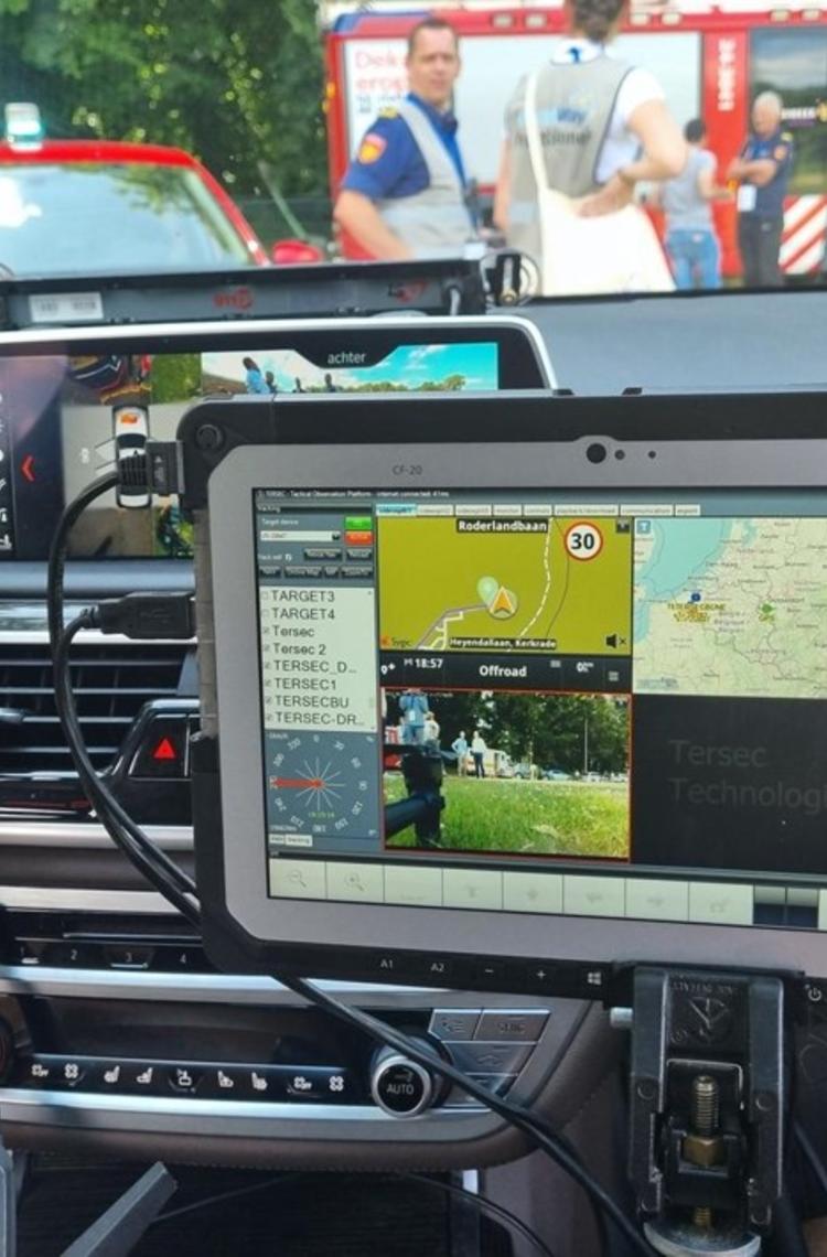 Broadway project mission critical app on a device in a car - fire departement in the back Broadway project mission critical app on a device in a car - fire departement in the back