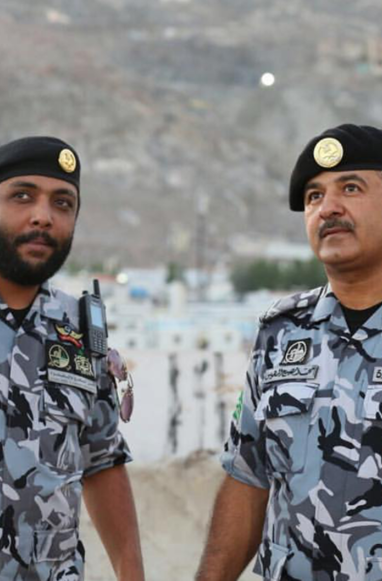 The Saudi radio communications - 2 saudi officers with tetra devices on the shoulder The Saudi radio communications - 2 saudi officers with tetra devices on the shoulder