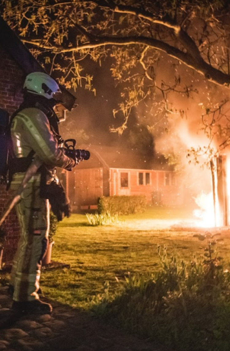 Firemen - 2 firemen fighting a forest fire at night Firemen - 2 firemen fighting a forest fire at night