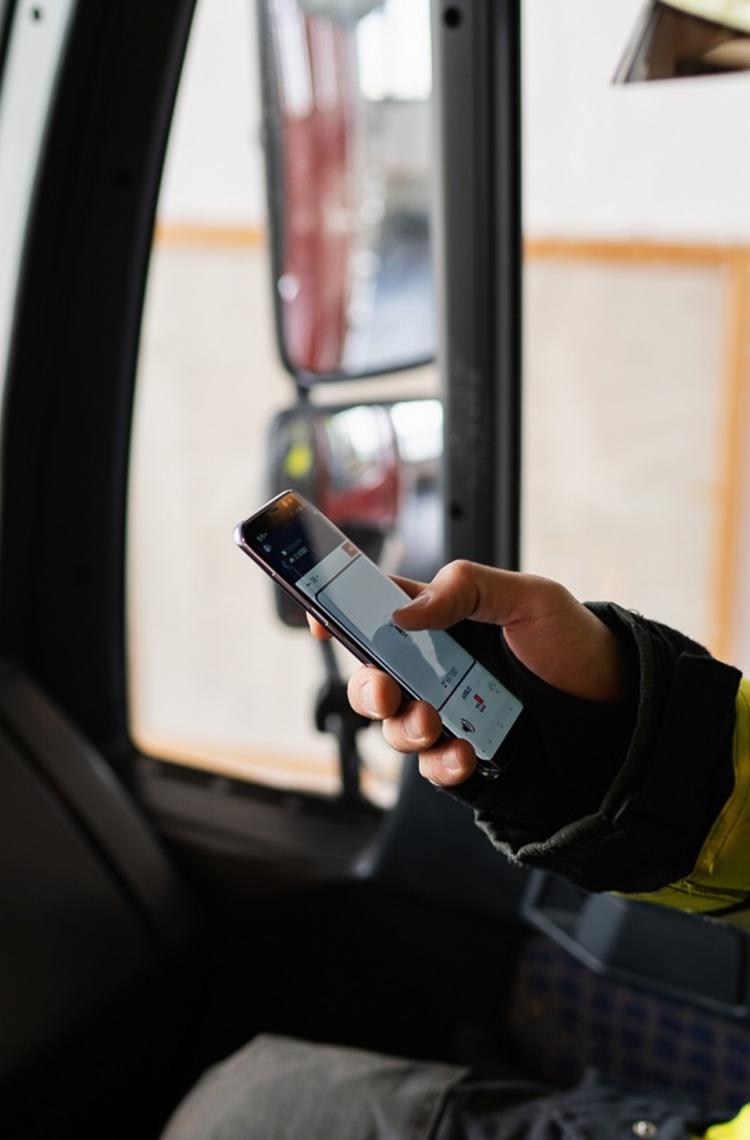 Fireman using Agnet PTT feature on his smartphone in his fire truck