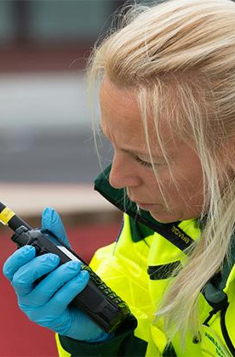 Paramedic talking to TH9 TETRA radio Paramedic talking to TH9 TETRA radio