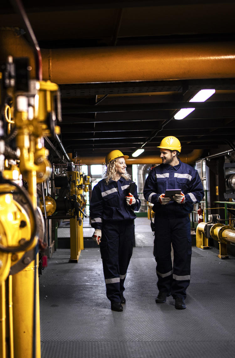 Industry workers checking the pipes for leaks and informing about the situation with Agnet