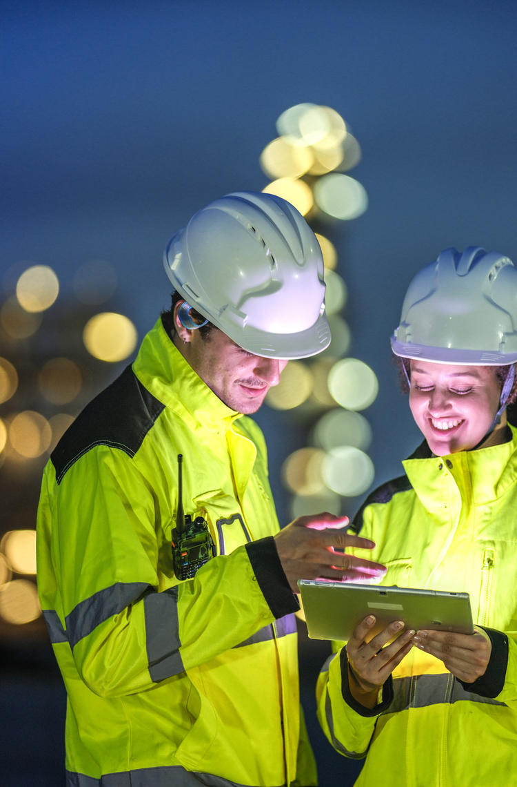 Industry professionals with a device