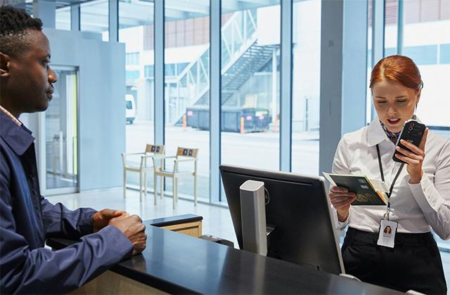 Airport professional uses smartphone