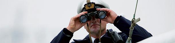 Coast guard with binoculars
