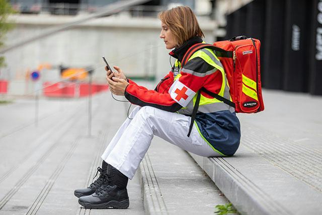 Paramedic at work uses a smartphone