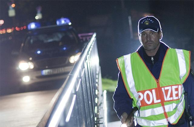Police at night with reflecting vest
