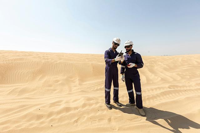 two energy professionals in desert with dabat