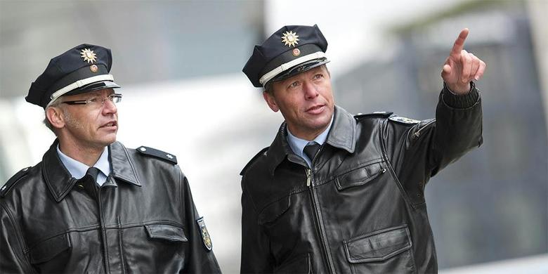 Two German police officers one pointing with finger