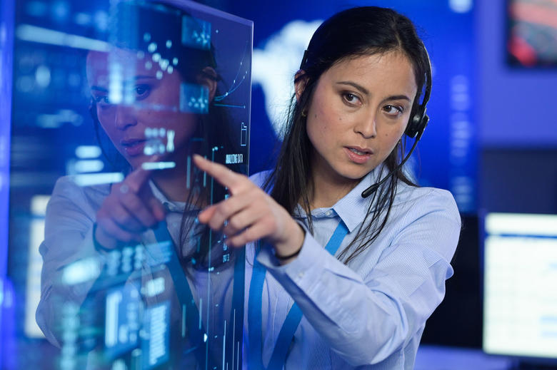 Command and control room operator pointing out an interesting fact from a transparent screen
