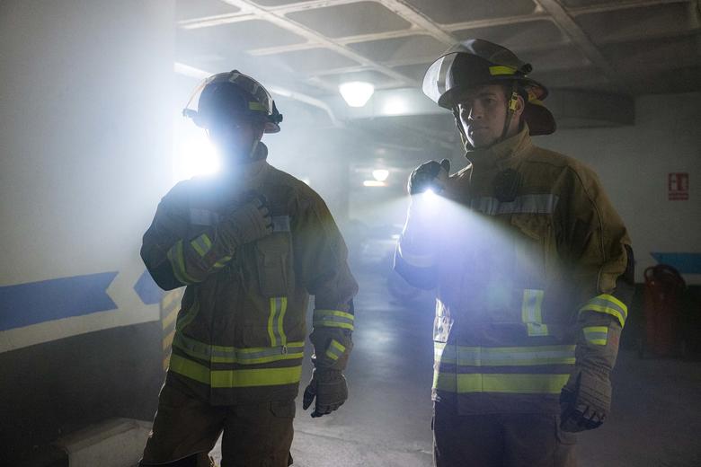 Firemen entering a building