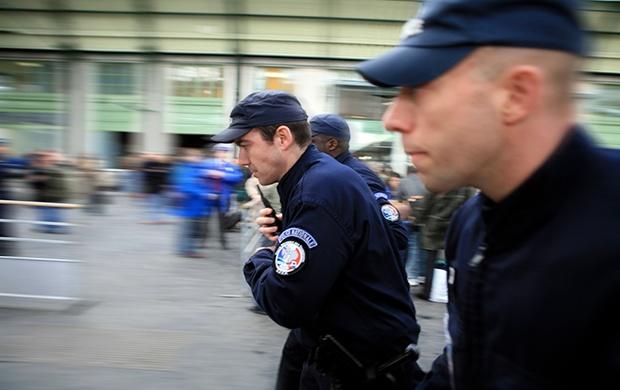 French police running at a railway station