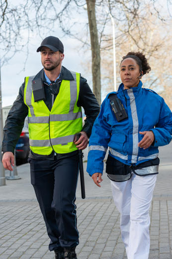 Paramedic and security guard walking