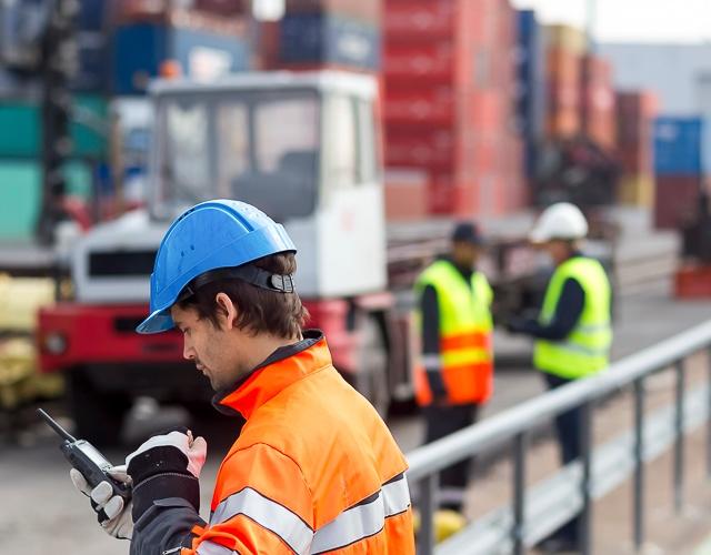 professional worker using TETRA radio in a port