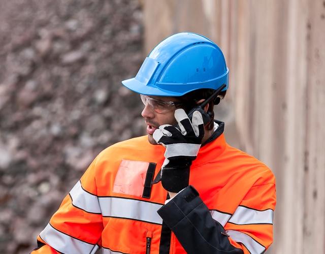 professional worker using TETRA radio in industrial plant