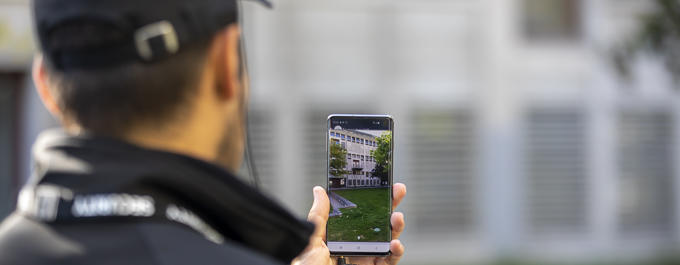Security profesional using video stream on his smartphone