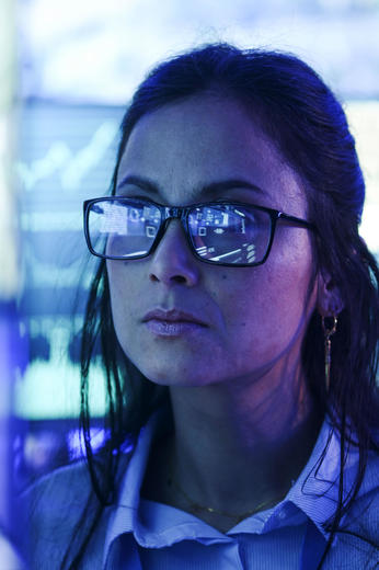 Command and control room operator reading data from a screen