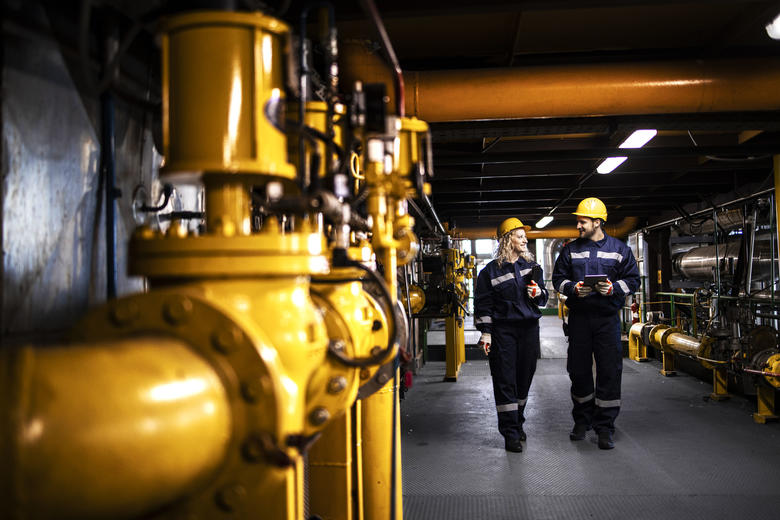 Industry workers checking the pipes for leaks and informing about the situation with Agnet