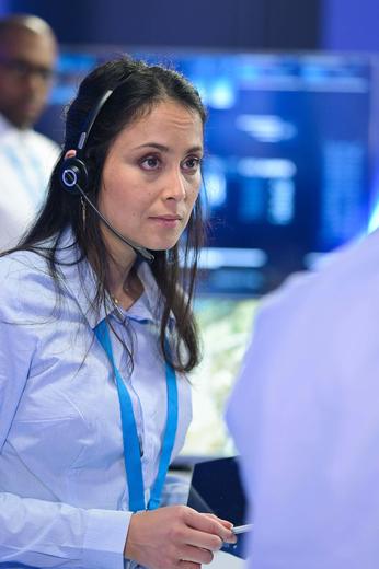 Control room operator discussing with a colleague